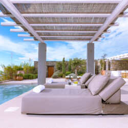 outdoor patio with private pool, sunbeds and an outdoor dining area in villa ammolite, mykonos