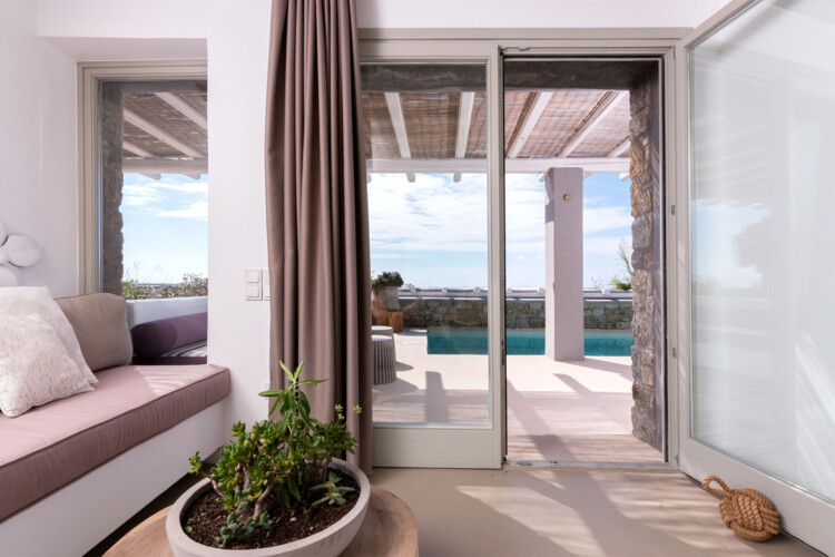 living room with a beautiful terrace at villa ammolite in mykonos