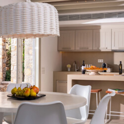 kitchen and dinning area with neutral tones and minimalistic interior design at villa ammolite in mykonos